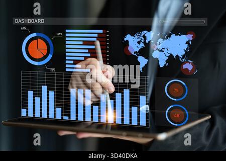 A business professional interacts with a tablet, showcasing various data visualizations and charts on a digital dashboard in a contemporary office Stock Photo