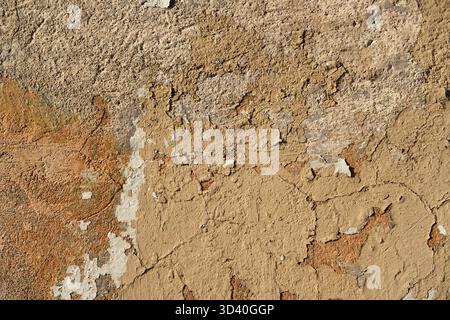 An old painted wall with peeling paint as a background Stock Photo