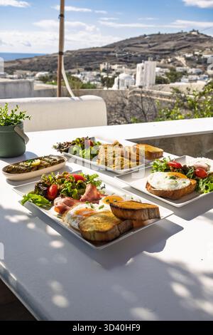 Breakfast and Brunch Spread Served Outdoors on a Terrace Overlooking a Mediterranean Village Stock Photo