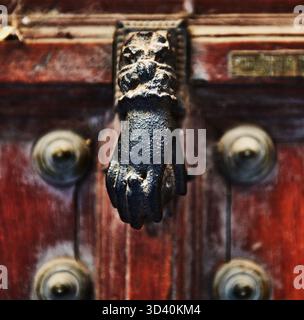 Detail of an old hand shaped door knocker, Toledo, Spain, Europe Stock Photo