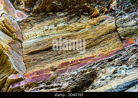 Nature force compressed cracked rock layers structure formation close-up details, in various shapes, colors, thicknesses, at north central coast of Cr Stock Photo