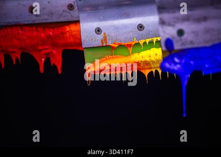 Smooth Transition of Rainbow Hues on Fabric Print Handles.    From red to violet, the colors merge gracefully on wooden handles, symbolizing creativit Stock Photo