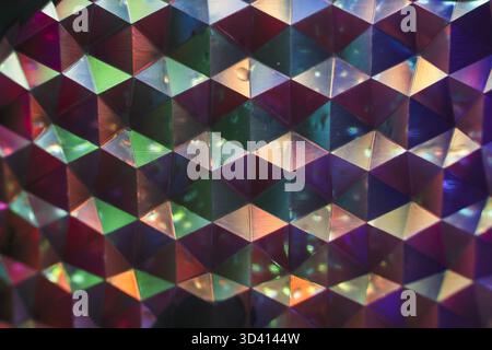 Mesmerizing abstract background with vibrant, colorful geometric pattern. shiny, metallic, and holographic surface has an iridescent texture, creating Stock Photo