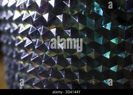 Mesmerizing abstract background of geometric pyramid pattern with holographic texture. futuristic metallic surface reflects iridescent light, creating Stock Photo