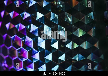 Mesmerizing holographic background with geometric pattern of cubes and triangles. vibrant, iridescent surface reflects light, creating futuristic visu Stock Photo