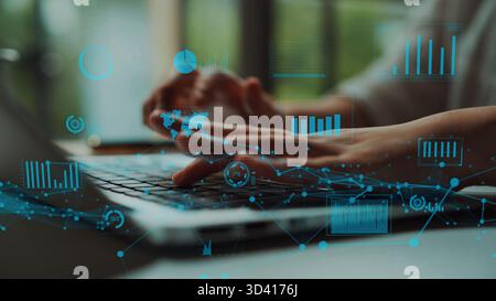 Close-up of hands typing on a laptop keyboard with overlay of digital graphs and data visualizations, representing modern technology and innovative Stock Photo