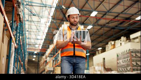 Warehouse, walking and man on tablet for supply chain, online inspection and shipment inventory. Distribution, storage depot and person on digital Stock Photo