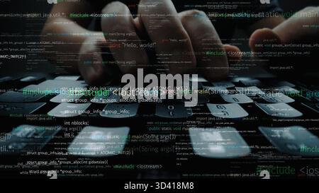 Close-up view of hands typing on a keyboard surrounded by programming code, illustrating the concepts of technology and coding in a dark, focused Stock Photo