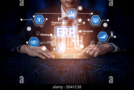 A business professional interacts with a digital interface showcasing ERP technology, focusing on key functionalities like planning and payroll Stock Photo