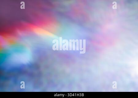 Soft colorful abstract background with blurred light reflections in purple, blue, and pink tones, creating a dreamy gradient texture. Stock Photo