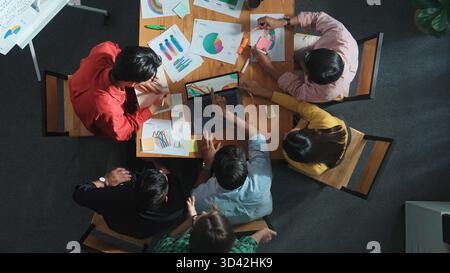 Top view of business team looking at laptop and analyzing chart. Close up of diverse group working on computer and reading financial report. Group of Stock Photo
