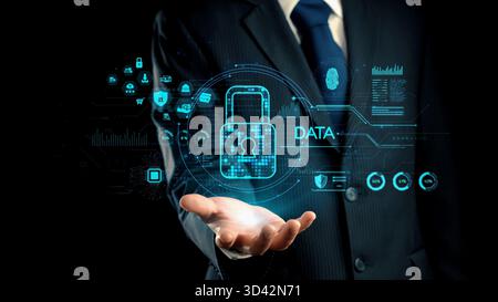A businessman presents a digital concept of data security featuring a lock symbol against a modern backdrop, emphasizing the critical importance of Stock Photo