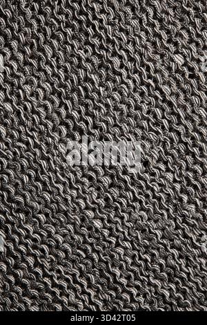 Abstract gray knitted fabric background. Wavy textile surface with detailed threads and organic pattern. Stock Photo