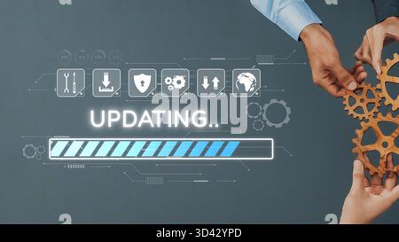 Two hands assemble gears against a digital backdrop with an updating progress bar, representing collaboration and the ongoing evolution in technology Stock Photo