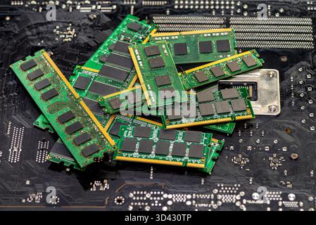 A stack of old SDRAM memory modules lying on a printed circuit board. Stock Photo