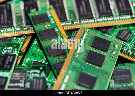 A stack of old SDRAM memory modules lying on a printed circuit board. Stock Photo