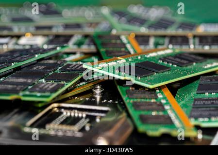 A stack of old SDRAM memory modules lying on a printed circuit board. Stock Photo