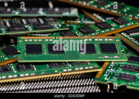 A stack of old SDRAM memory modules lying on a printed circuit board. Stock Photo