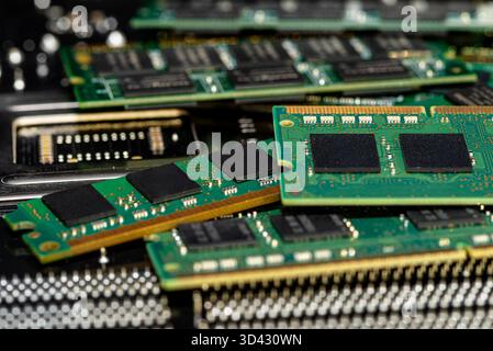 A stack of old SDRAM memory modules lying on a printed circuit board. Stock Photo