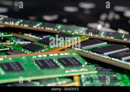 A stack of old SDRAM memory modules lying on a printed circuit board. Stock Photo