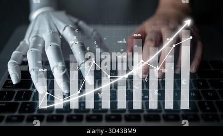 A close-up view of a robotic hand interacting with a keyboard while displaying dynamic financial graphs, symbolizing the fusion of technology and Stock Photo