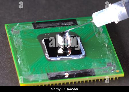 Application of liquid metal to the processor to install a cooling system. Stock Photo