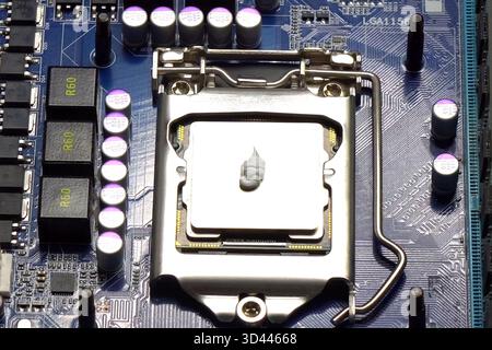 Drawing thermal paste on the computer processor. Installing a cooling system on a CPU processor Stock Photo