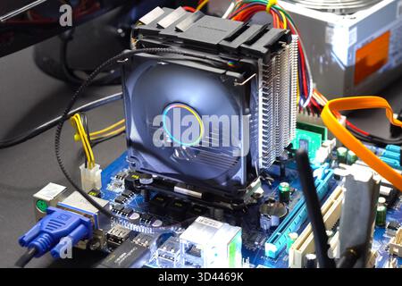 CPU cooling system. Cooler with a radiator on the motherboard. Stock Photo