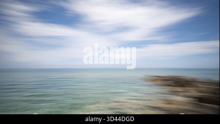 Abstract seascape with blurred waves and streaked clouds. Nature water background Stock Photo