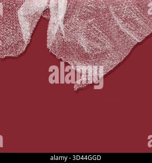 Bubble wrap with shadow against red background Stock Photo