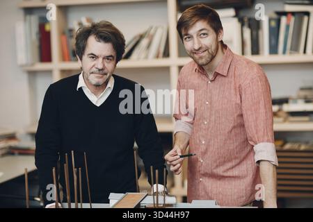 Architect with blueprints and layout design project at office bureau Stock Photo