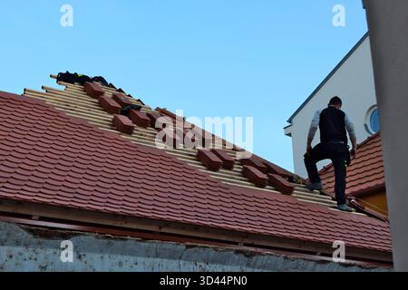 Roofer on a roof Stock Photo