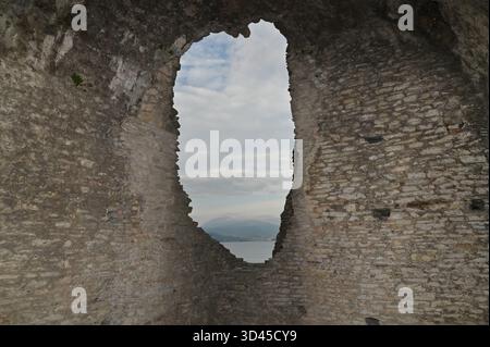 Hole In The Wall Of The Ruins In The Grottoes Of Catullus At Lake Garda In Sirmione Italy On A Wonderful Sunny Autumn Day With A Few Clouds In The Sky Stock Photo