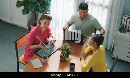 Top down view of project manager present idea while holding tablet at meeting. Skilled business team discussing and planning marketing strategy. Group Stock Photo