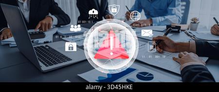 Red warning triangle representing a cybersecurity threat or data breach alert, surrounded by digital security and network protection icons Stock Photo