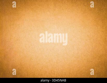 Golden yellow color paper background texture. Sheet of bright beige arts and crafts cardboard with rough textured grain surface. Stock Photo