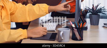 Engaging office scene featuring a diverse team in a creative meeting, using digital and traditional tools for brainstorming and idea sharing. SACTR Stock Photo