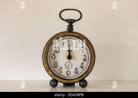 Stylish old alarm clock showing the time 12. Central position. Concept, New year, deadline, time change. close up Stock Photo
