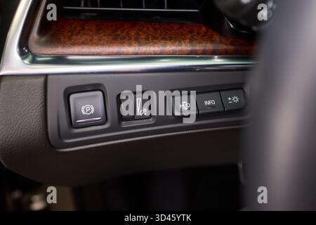 Closer view of dashboard controls featuring illumination and safety icons, Detailed snapshot of vehicle dashboard with various illuminated safety and Stock Photo