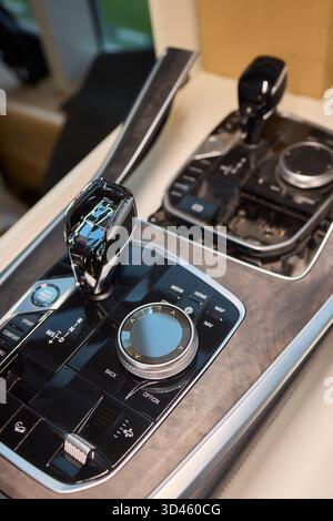 Automotive gear overview, Urban inspired vehicle interior showing gear shift and control features, Detailed shot of car gear selector with glossy knob Stock Photo