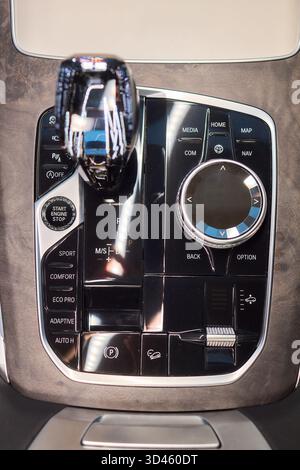 Automotive gear overview, Urban inspired vehicle interior showing gear shift and control features, Detailed shot of car gear selector with glossy knob Stock Photo