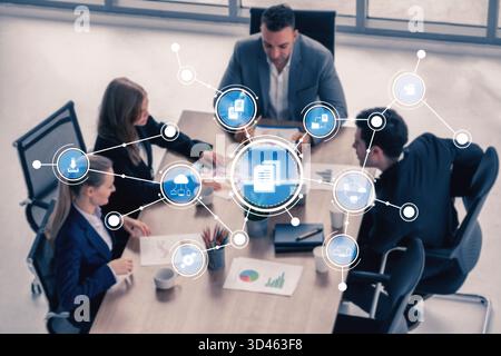 A group of business professionals engages in discussion around a conference table, enhanced by a digital interface showing analytics and data Stock Photo