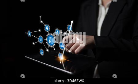 A business professional uses a stylus on a tablet, engaging with a digital interface. This image highlights technology and innovation, enhancing Stock Photo