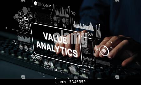 Hands Typing on Keyboard with Digital Value Analytics Display and Data Visualization Graphics in a Dark Environment. Asymptotic smart data analytic. Stock Photo