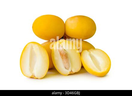 Fresh ripe yellow Barhi date palm fruits with halves in stack are isolated on white background with clipping path. Concept of iftar food in Ramadan Stock Photo