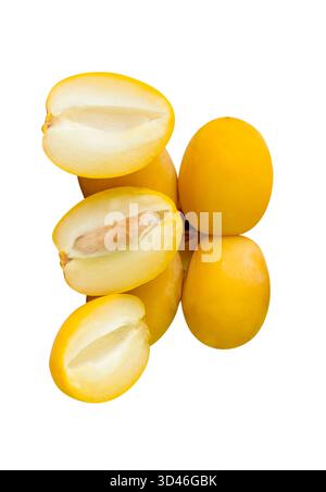 Fresh ripe yellow Barhi date palm fruits with halves in stack are isolated on white background with clipping path. Concept of iftar food in Ramadan Stock Photo