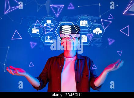 This image depicts a person interacting with digital data storage concepts in a vibrant, abstract environment, showcasing cloud computing and Stock Photo