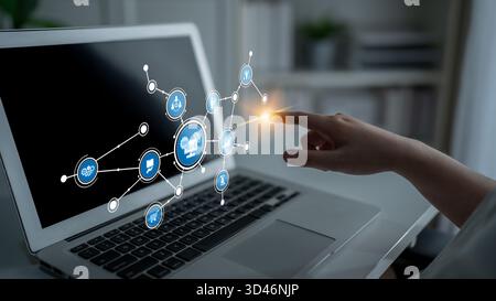 A user interacts with a digital interface on a laptop screen featuring icons that symbolize modern technology and connectivity in a professional Stock Photo