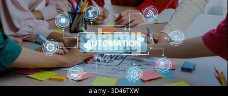Hands engaged in collaboration while developing automation strategies with digital icons and colorful sticky notes, symbolizing innovative business Stock Photo