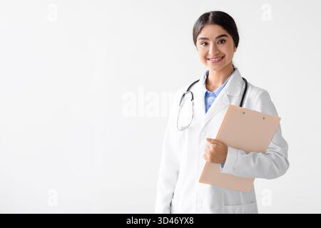 Young Friendly Indian Female Doctor in Uniform With Tablet Posing on a White Background Stock Photo